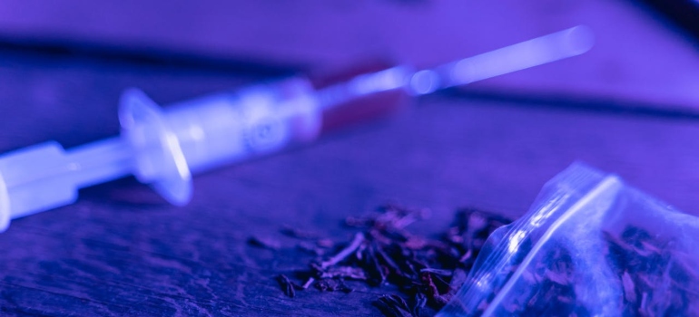 a syringe and a plastic bag on the table 