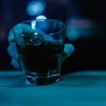 a man holding a glass of alcohol