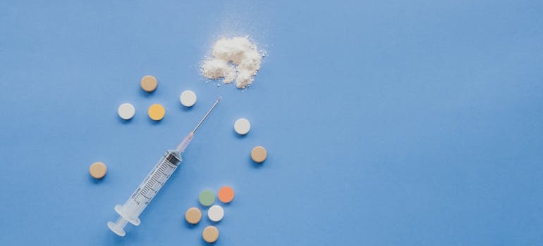 Syringe next to tablets.