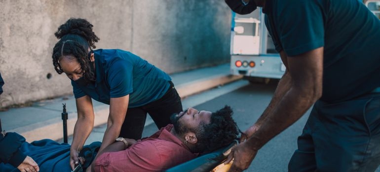 Paramedics providing emergency care to an unconscious person who ingested pink cocaine.