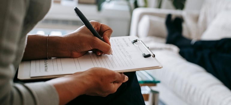 psychologist writing on clipboard