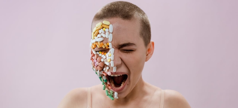 Woman with pills on her face