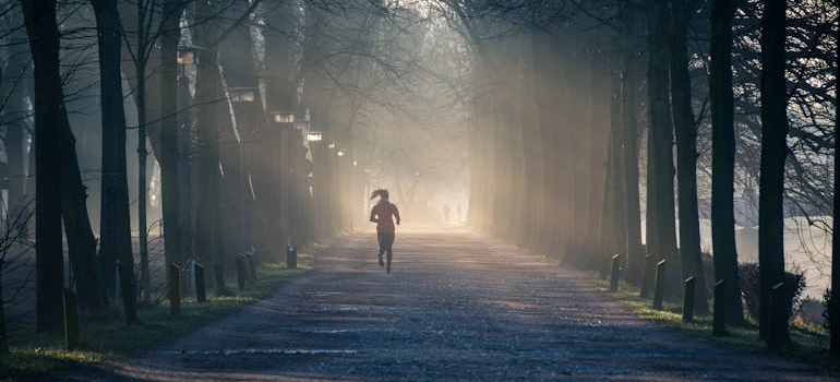 Woman running in the park on Mental Health Day.