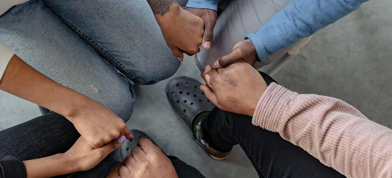 People holding hands in support. 