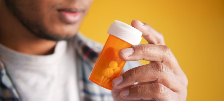 A man holding medicine bottle