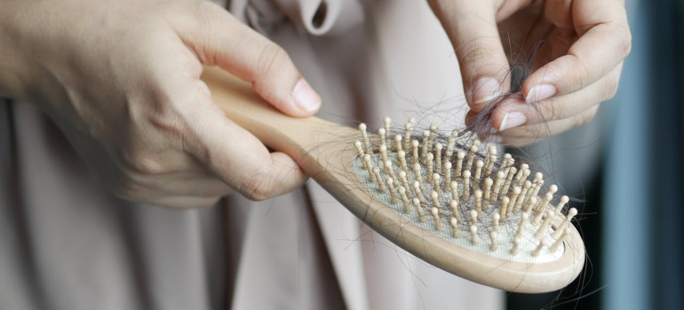 Hair brush with hair, symbolizing illegal drugs that cause hair loss