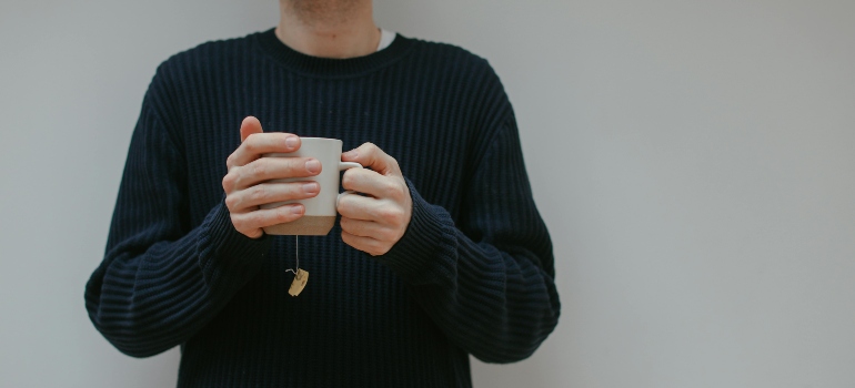 Man holding a mug of tea.