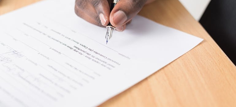 Man signing a document.