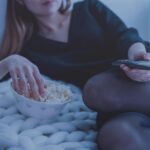 a girl at home watching tv and representing the link between Introverts and Drug Use
