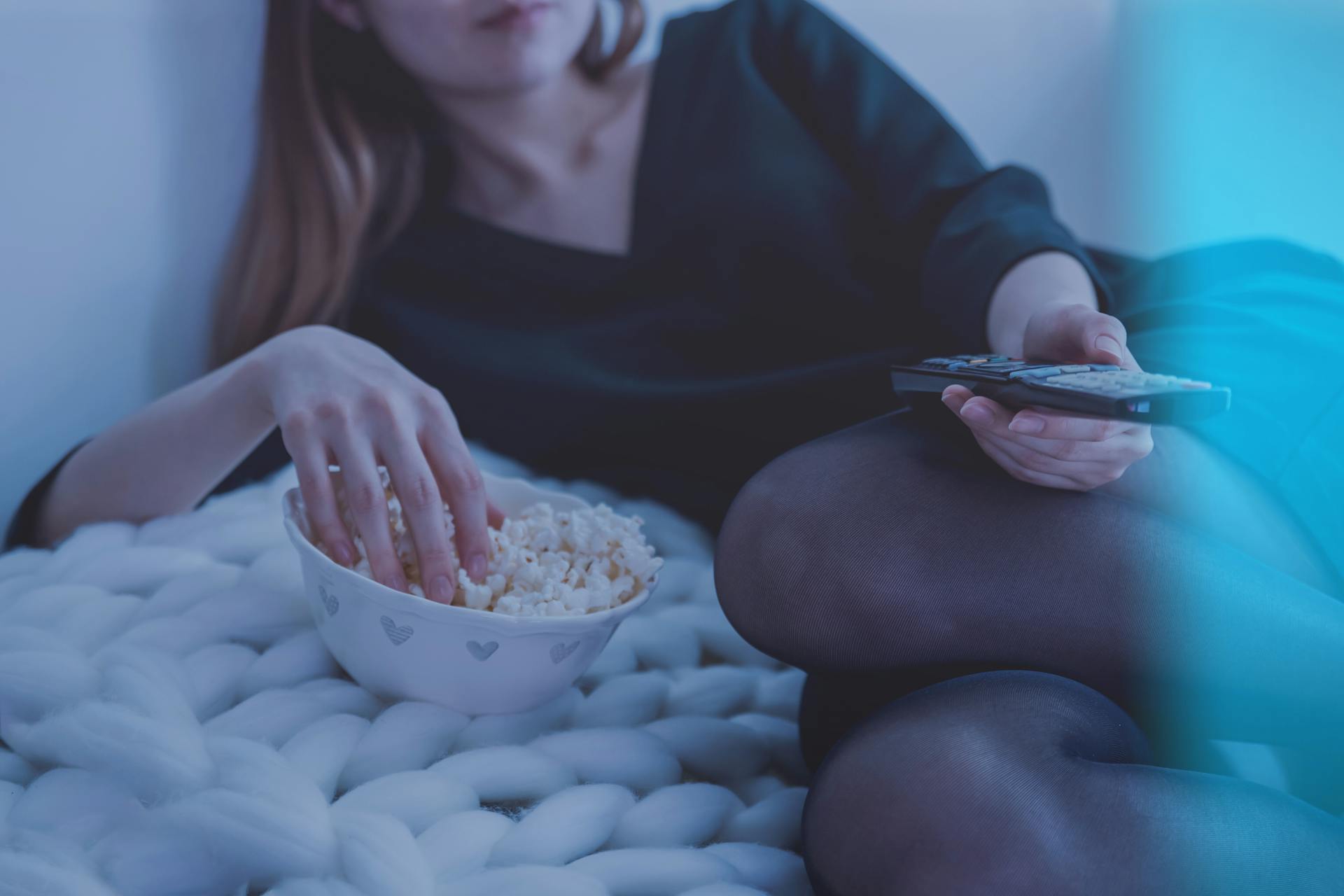 a girl at home watching tv and representing the link between Introverts and Drug Use