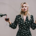 Woman drinking wine and talking about bipolar disorder and alcohol abuse