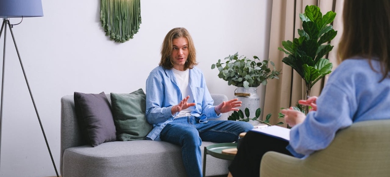 Man talking to a therapist about why is prescription drug abuse on the rise.