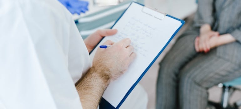 Man writing on a clipboard.