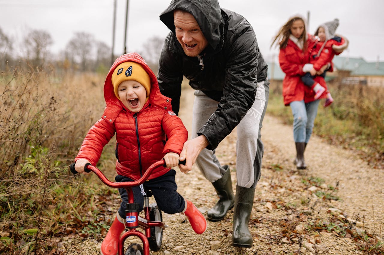 Father teaching his son to ride a bike.