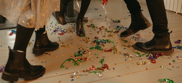 Three people on the dancefloor with confetti.