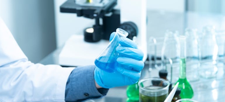 Scientist holding a lab dish.