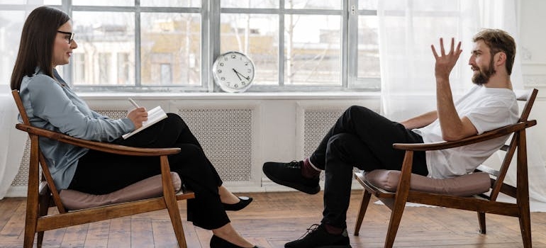 Man discussing his issues with antipsychotics and alcohol addiction with his therapist.