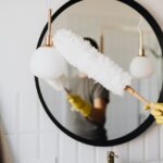 Person dusting a mirror.