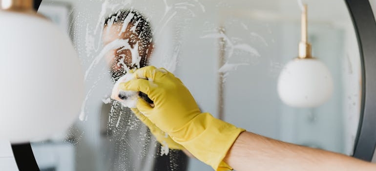 Man scrubbing a mirror.