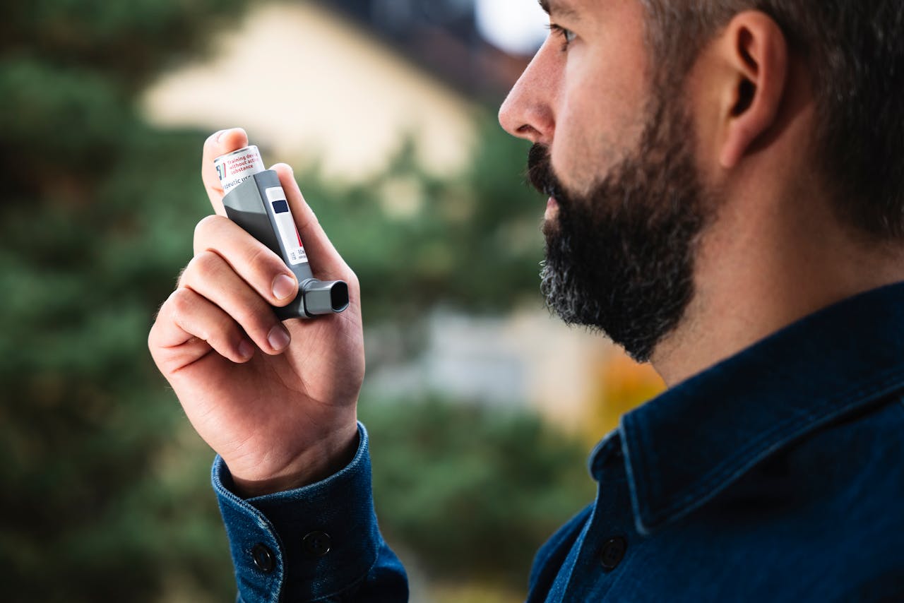 Man using an inhaler.