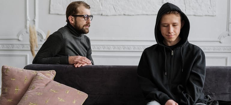 Therapist talking to a child and helping a child whose parent is struggling with addiction.