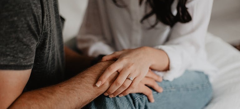 Woman holding a man's hand.