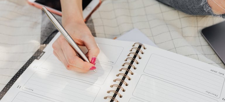 Woman writing in her journal and structuring her day.