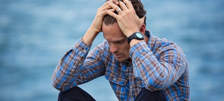 Man holding his head with his hands.