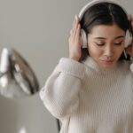Woman listening to music while wearing headphones.