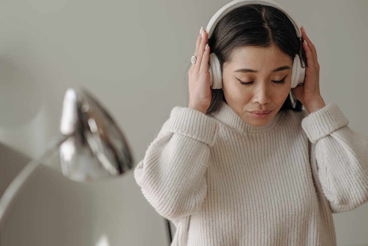 Woman listening to music while wearing headphones.