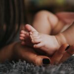 Woman holding her baby's feet.