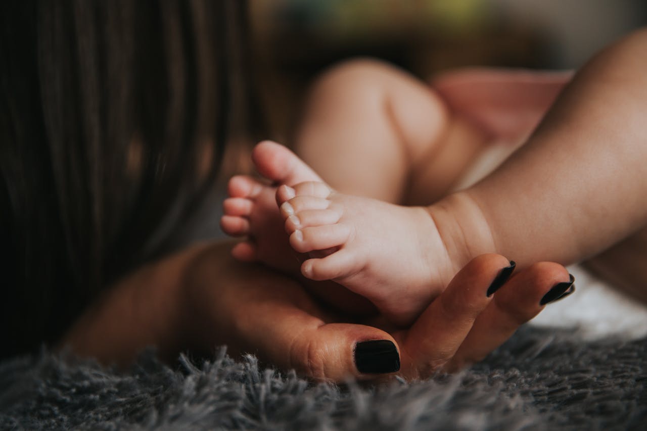 Woman holding her baby's feet.