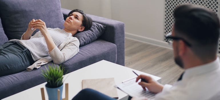 Woman lying on the couch and talking to her therapist.