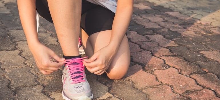 Woman tying her shoelaces.