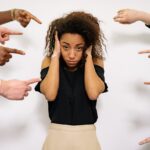 Hands pointing to a woman.