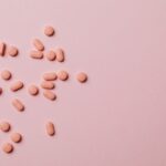 Pink pills on a pink background.