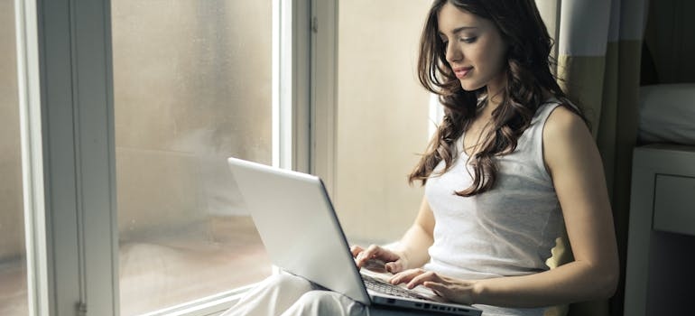 Woman researching PHP vs inpatient options on her laptop.