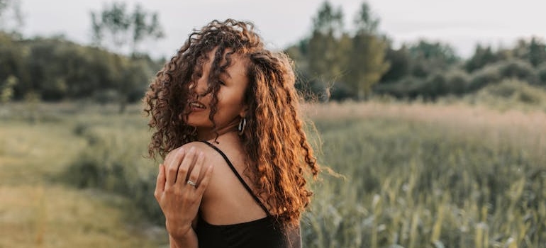 Woman hugging herself and practicing self-forgiveness in recovery.