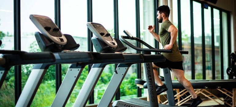 Man running on the treadmill to help with addiction cravings.