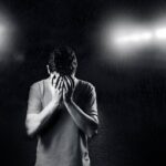 Man hiding his face with his hands.
