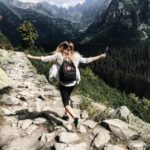 Woman hiking up a hill and attending outdoor therapy.