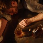 Man lying on the table and drinking whiskey.