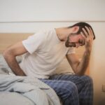 Man experiencing bad symptoms of alcohol detox at home.