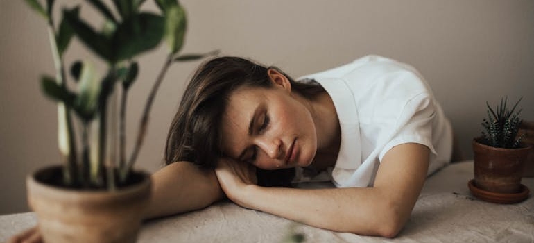 Woman asleep on a table.