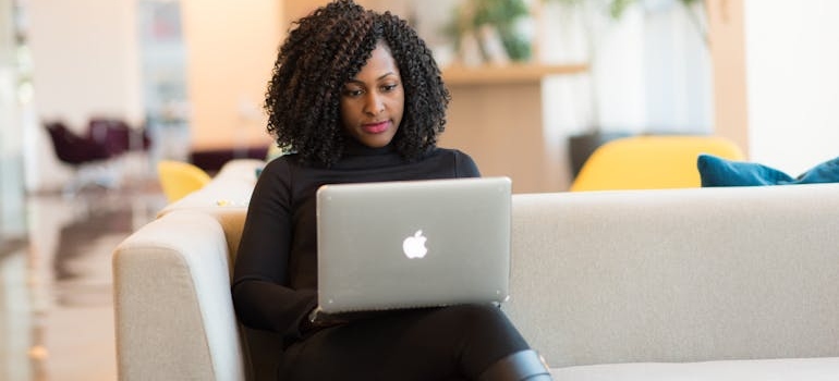 Woman researching on her laptop while choosing OTP program.