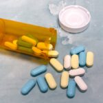 Pills spilling out of the bottle.