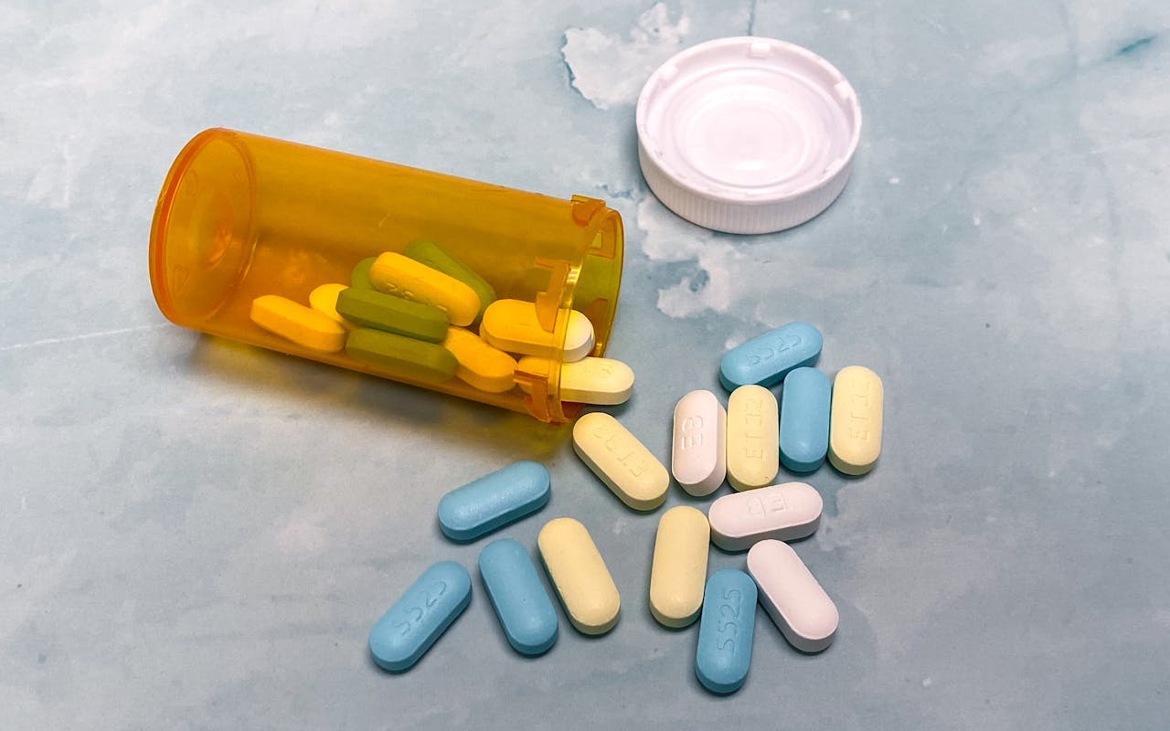 Pills spilling out of the bottle.