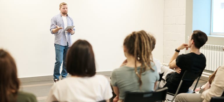 Man doing a lecture on drugs and personality types to high school students.