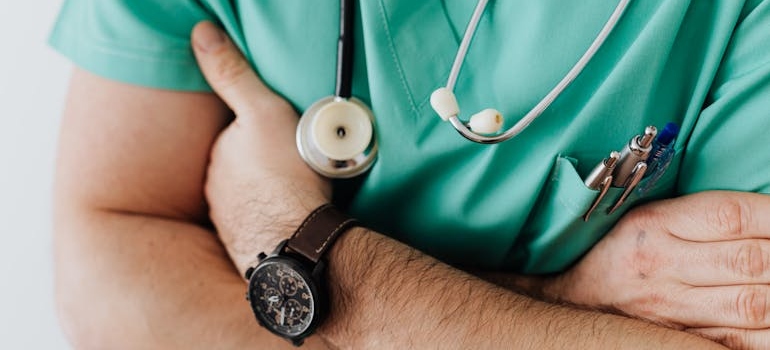 Doctor standing with crossed arms.
