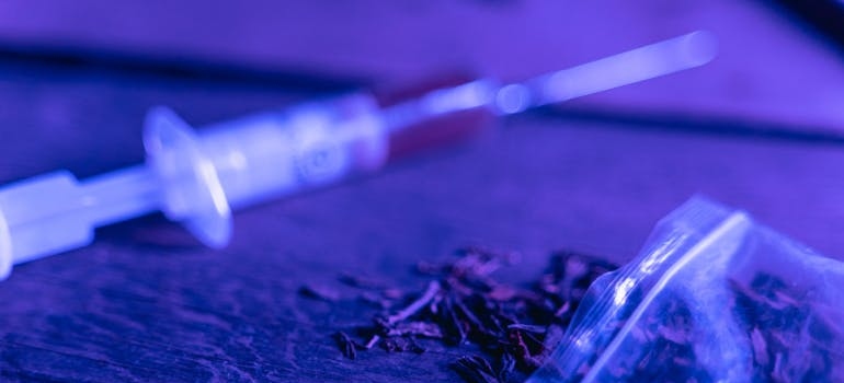 Syringe next to a Ziplock bag.
